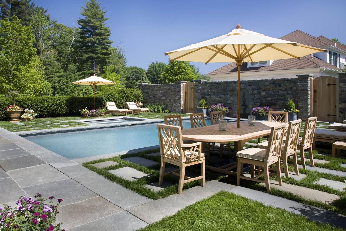 Pool with outdoor dining table and lounge chairs