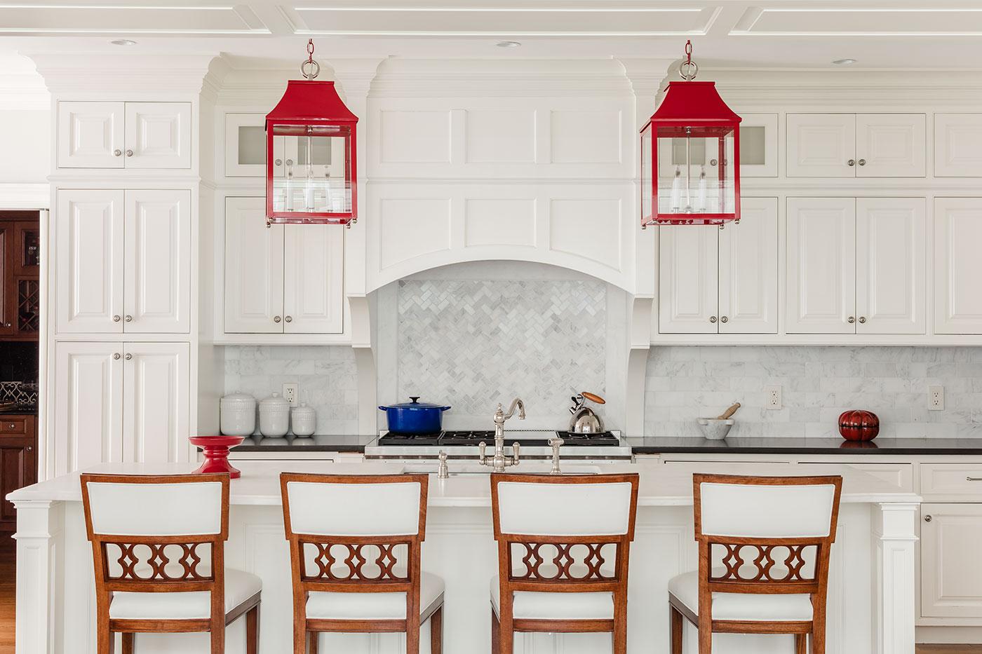 High-end red, white and blue kitchen design by Carter & Company Interior Design